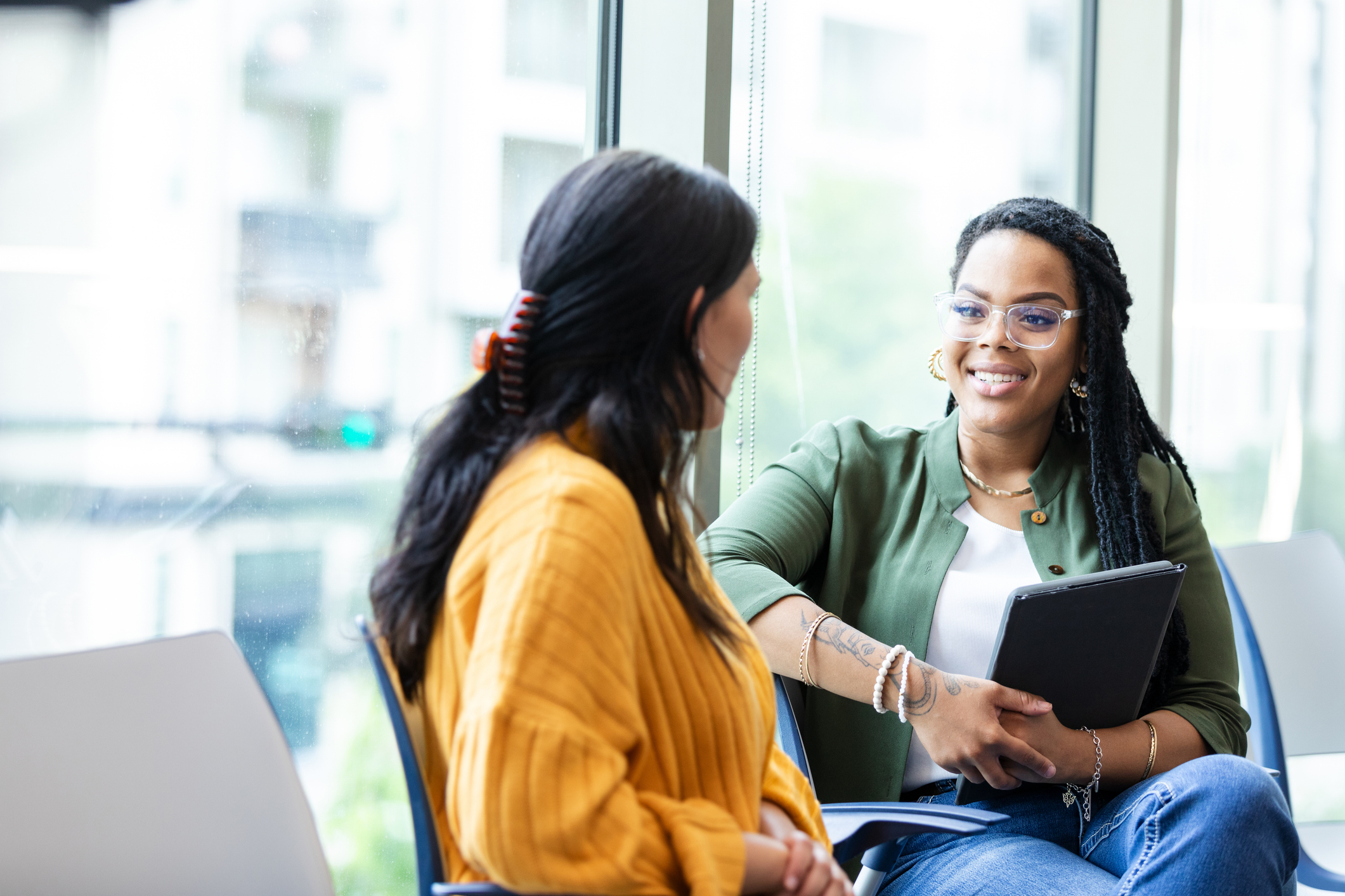 Female therapist listens attentively to young female student